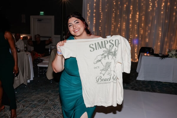 The bride and groom opted for a T-shirt toss instead of a bouquet toss, and the shirts were a huge hit!