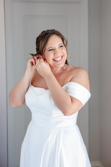 A bride putting on her earrings before her Clearwater Beach wedding.