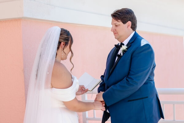 A bride and groom exchange wedding vows in private before their Clearwater Beach wedding.
