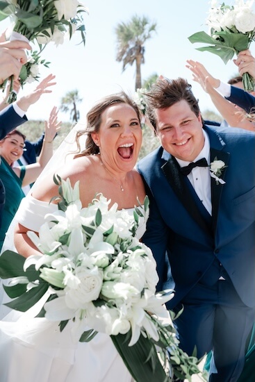 A bride and groom having fun with their wedding party before their Clearwater Beach wedding.