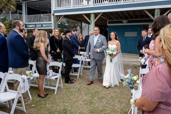 A bride and her father walking down the aisle at Tampa Bay Watch.