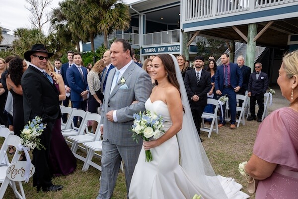 A bride and her father walking down the aisle at Tampa Bay Watch.