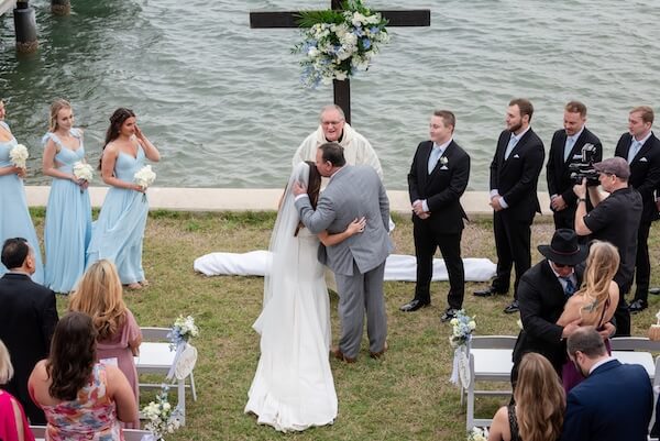 A bride and her father walking down the aisle at Tampa Bay Watch.