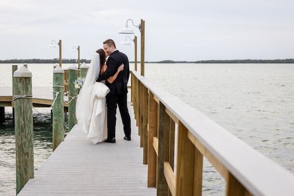 A newlywed couple's waterfront wedding portraits at Tampa Bay Watch.