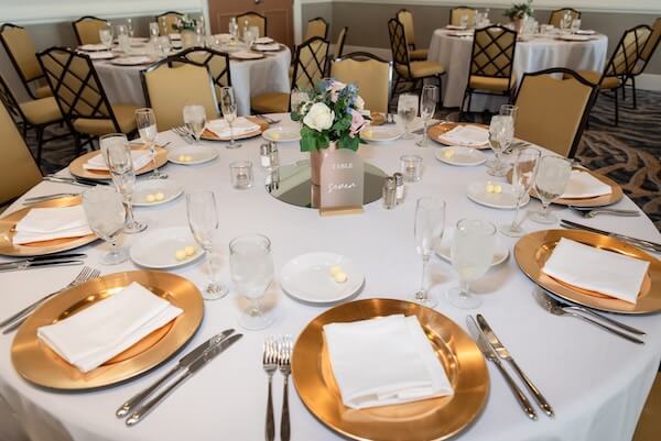 Gold and white wedding reception decor.
