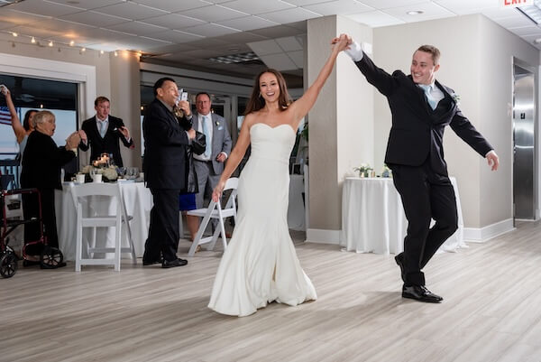 A newlywed couple's grand entrance at their Tampa Bay Watch wedding reception.