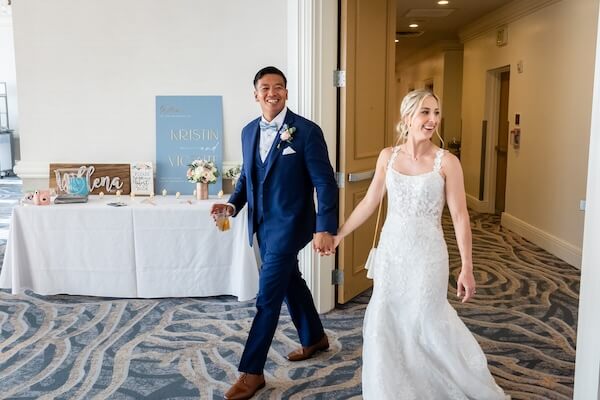 A newlywed couple is taking a sneak peek at their wedding reception. 