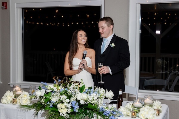A newlywed couple welcoming guests.