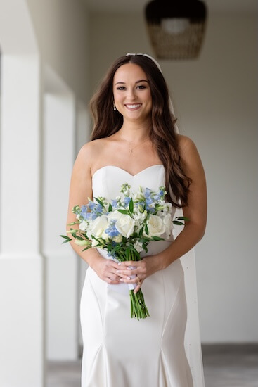 A bride with her bouquet before her Tampa Bay Watch wedding.