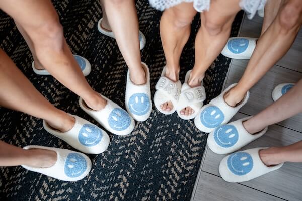 A bridal party wearing fun smiley face slippers.
