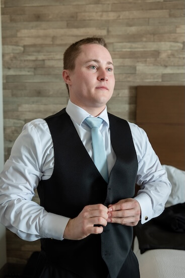 A gromm getting dressed for his big day.