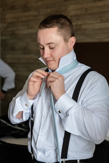 A groom getting dressed for his Tampa Bay Watch wedding.