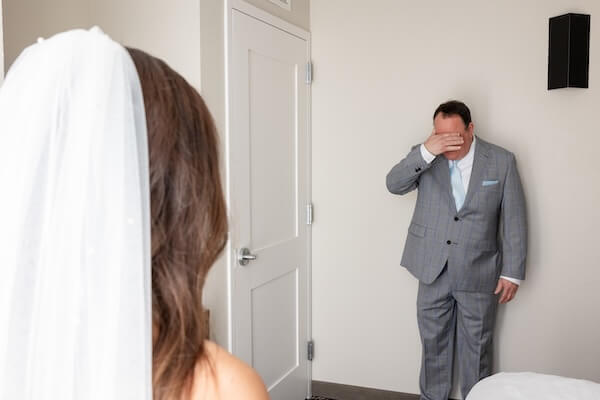 The father of the bride seeing his daughter before her Tampa Bay Watch wedding.