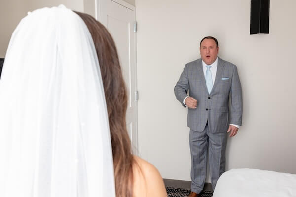 The father of the bride seeing his daughter before her Tampa Bay Watch wedding.