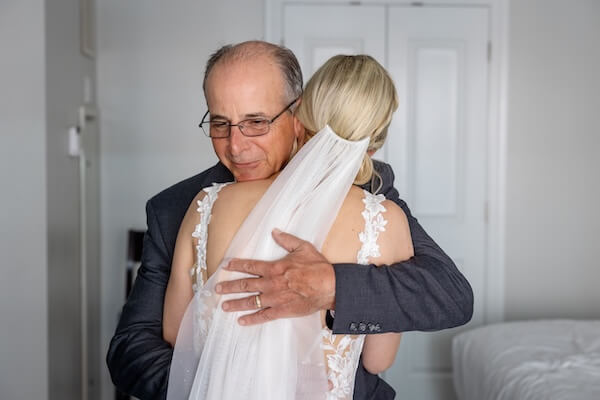 A dad has his first look and private moment with his daughter before her Hyatt Clearwater wedding.