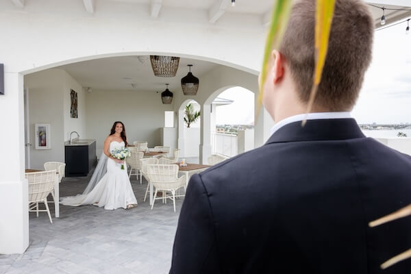 A bride and groom's first look before their Tampa Bay Watch wedding.