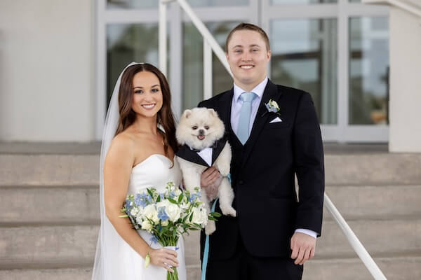 Bride, grrom and their dog before their Tamp Bay Watch wedding.