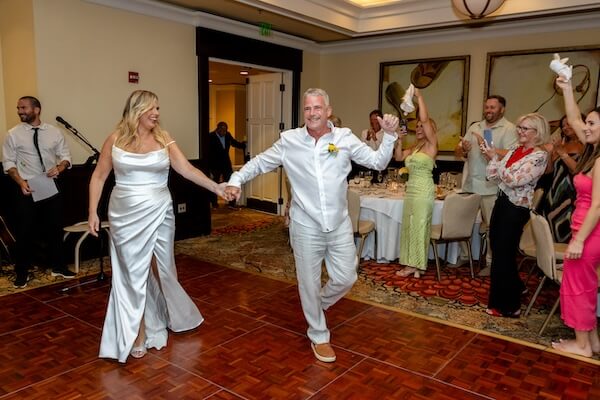 A bride and groom making their grand entrance at their Clearwater Beach wedding reception.