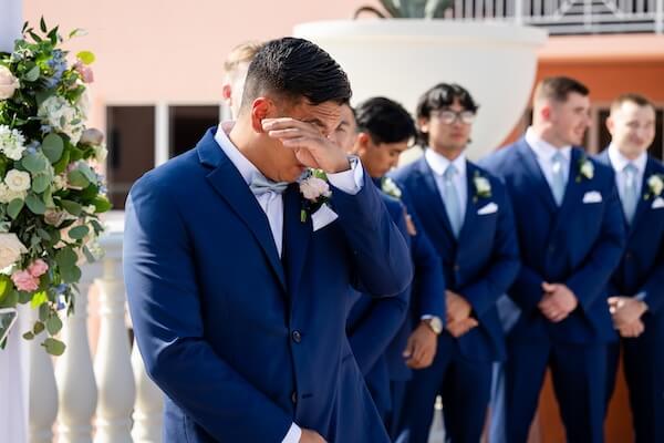 An emotional groom as he sees his bride walking down the aisle.