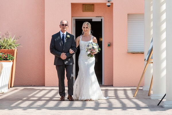 A bride and her father walking down the aisle at the Hyatt Regency Clearwater.