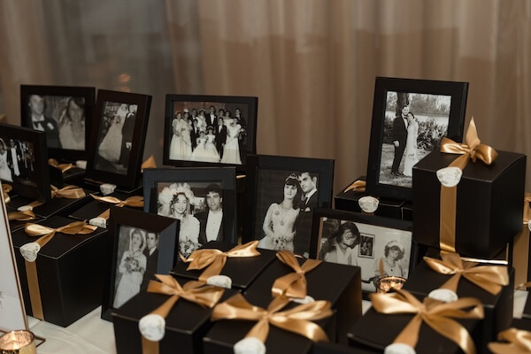 A cookie table decorated with lots of family photos.