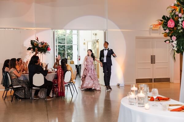 A newlywed couple's grand entrance at their Tampa Garden Club wedding.