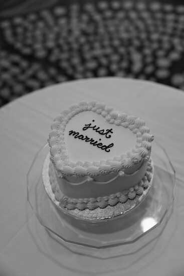an intimate heart shaped wedding cake with Just Married written on top.