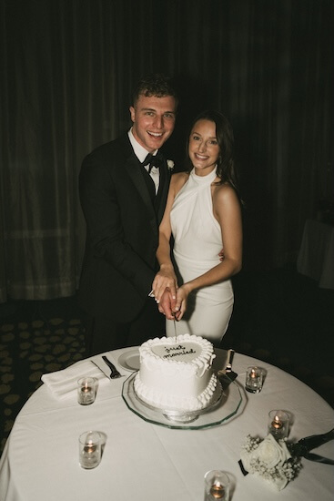 A birde and groom cutting their wedding cake.