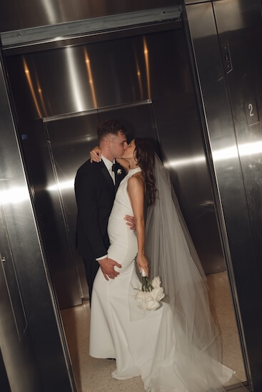 Bride and groom in the elvator after thier Opal Sands wedding.