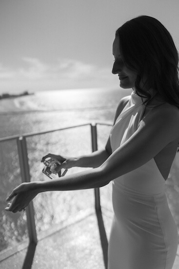 A bride putting on her wedding perfume.