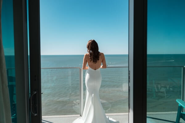 A bride on her Opal Sands balcony beofre her wedding.