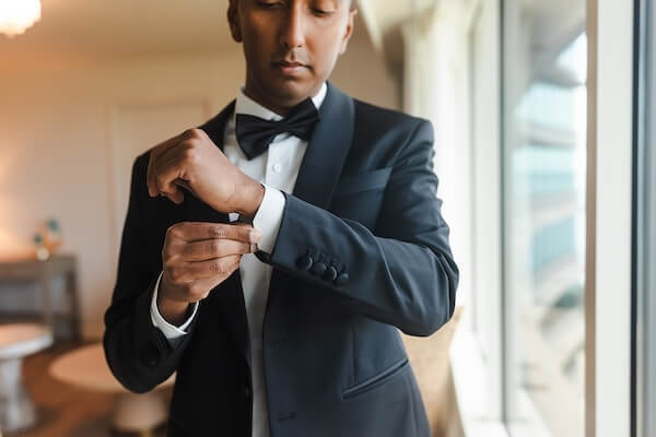 A groom putting the final touches on his accessories beofre his Tampa Garden Club wedding.