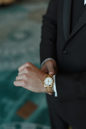 A groom putting on his watch.