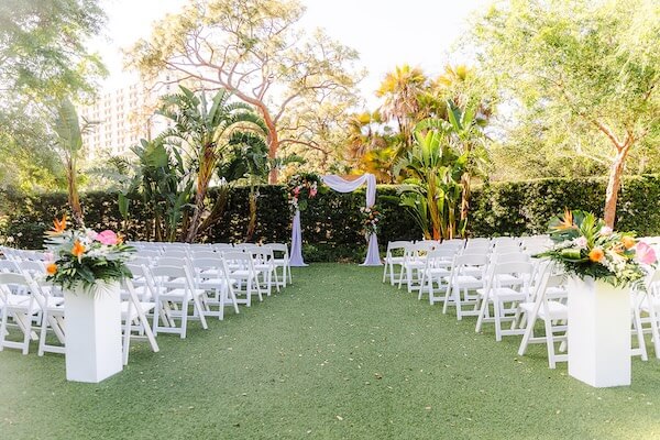 A tropical outdoor ceremony for a Tampa Garden Club wedding.