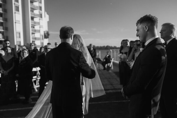 The father of the bride presenting his daugther to the groom.