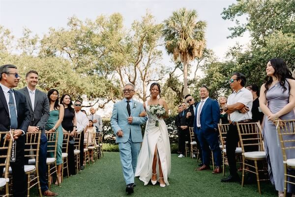 A birde and her father walking down the aisle at the Tampa Garden Club.