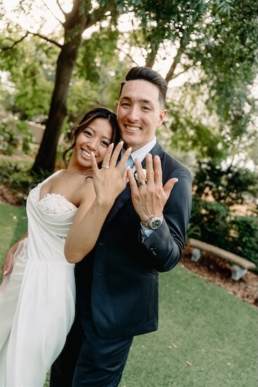 A newlywed couple showing off their new arings after their Tampa wedding.