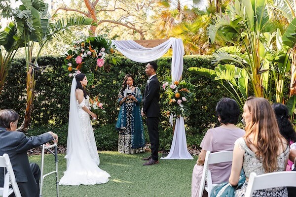 An outdoor wedding ceremony at the Tampa Garden Club.