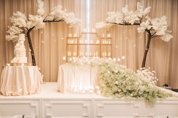 A stweetheart table and wedding cake at a Clearwater wedding reception.