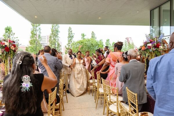 Newlywed couple making their entrance at their Tampa Museum of Art wedding reception.