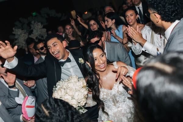 A birde and grtoom celebrating with family and friends at their Clearwater wedding.