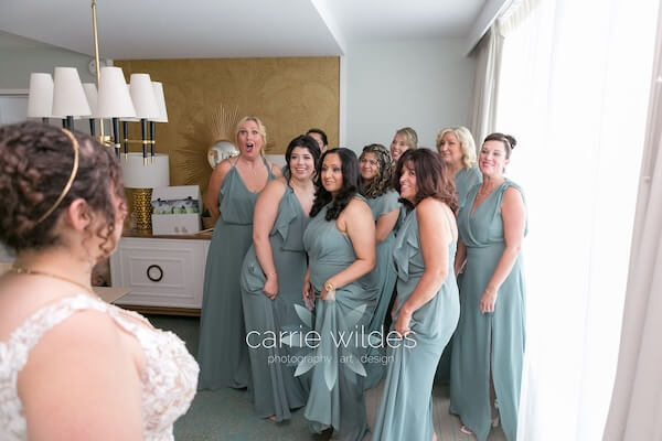 A bride's reveal with her her wedding party at the Wyndham Grand Clearwater Beach.