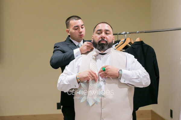 A groom dressing for his Wyndham Grand Clearwater Beach wedding.