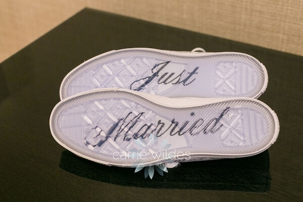 Just Married on the bottom of a groom's converse sneakers.