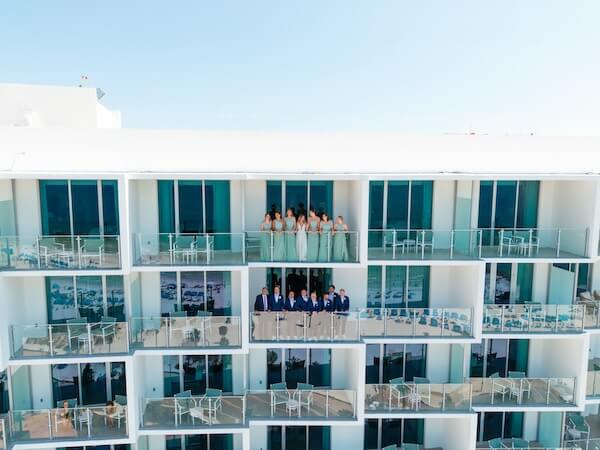 Wedding parties on balconies at the Opal Sands Resort.