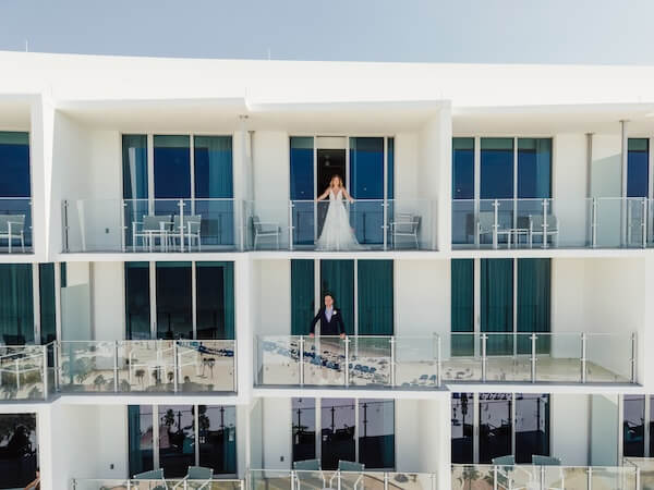 Bride and groom on Opal Sands balconies.