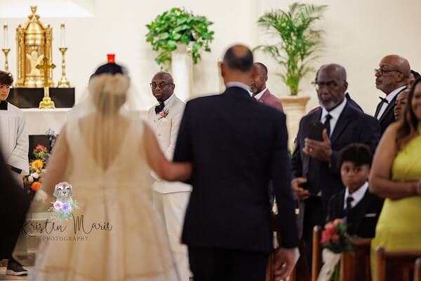 A Tampa bride walking down the aisle with her father.