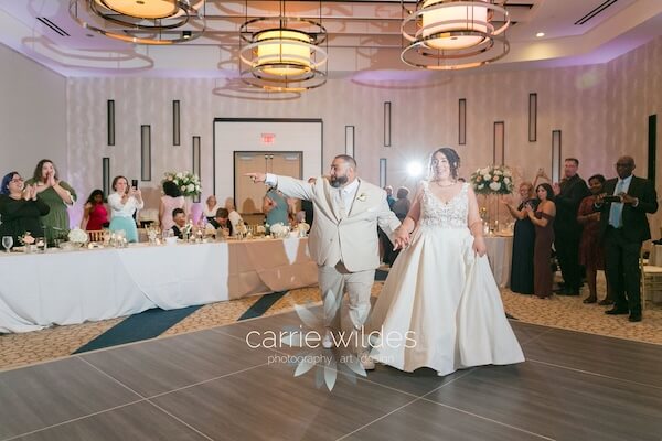 A newlywed couple's grand entrance at their Wyndham Grand Clearwater Beach wedding reception.